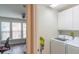Bright laundry room with washer, dryer, and ample cabinet storage at 5800 Oakdale Rd # 103, Mableton, GA 30126