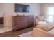 Main bedroom with large dresser and sitting chair at 5800 Oakdale Rd # 103, Mableton, GA 30126
