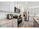 Modern kitchen with stainless steel appliances and granite countertops at 7557 Knoll Hollow Rd, Lithonia, GA 30058