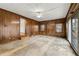 Large basement room with wood paneling, and ceiling fan at 108 Woodhaven Dr, Stockbridge, GA 30281