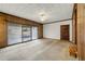 Finished basement with wood paneling, sliding glass doors and ceiling fan at 108 Woodhaven Dr, Stockbridge, GA 30281