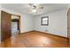 Bedroom with hardwood floors, a window and access to patio at 108 Woodhaven Dr, Stockbridge, GA 30281