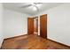 Hardwood floor bedroom with ceiling fan and multiple doors at 108 Woodhaven Dr, Stockbridge, GA 30281