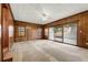 Spacious living room with wood paneling and sliding glass doors at 108 Woodhaven Dr, Stockbridge, GA 30281