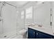 Clean bathroom with walk-in shower and blue vanity at 151 Nacoochee Way, Canton, GA 30114