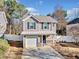 Two-story house with gray siding, white garage door, and a landscaped yard at 151 Nacoochee Way, Canton, GA 30114