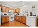 Well-equipped kitchen with wood cabinets, white appliances and hardwood floors at 151 Nacoochee Way, Canton, GA 30114