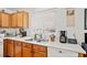 Clean kitchen with wood cabinets, white appliances and hardwood floors at 151 Nacoochee Way, Canton, GA 30114