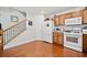 Modern kitchen with wood cabinets, white appliances and hardwood floors at 151 Nacoochee Way, Canton, GA 30114