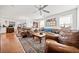 Spacious living room featuring hardwood floors, comfortable seating, and a ceiling fan at 151 Nacoochee Way, Canton, GA 30114