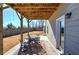 Covered patio with table and chairs, overlooking fenced yard at 201 Augusta Walk, Canton, GA 30114