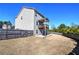 A fenced backyard featuring a two-story home with a deck and a small patio, offering a private outdoor space at 201 Augusta Walk, Canton, GA 30114