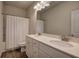 Bathroom with double vanity, white cabinets, and shower/tub at 201 Augusta Walk, Canton, GA 30114