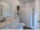 Clean bathroom with white vanity, mirror, and a shower with a striped curtain at 201 Augusta Walk, Canton, GA 30114