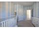 Bedroom with blue and white striped walls and crib at 201 Augusta Walk, Canton, GA 30114