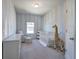 Bedroom with blue and white striped walls, crib, and glider at 201 Augusta Walk, Canton, GA 30114