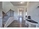 Bright entryway with wood-look floors, staircase, and console table at 201 Augusta Walk, Canton, GA 30114