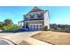 Two story house with gray siding, a three car garage and a manicured lawn at 201 Augusta Walk, Canton, GA 30114