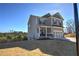 Two-story house with gray siding, a covered porch, and a large backyard at 201 Augusta Walk, Canton, GA 30114