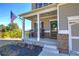 Charming front porch with rocking chairs and a wreath on the door at 201 Augusta Walk, Canton, GA 30114