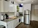 Bright kitchen featuring granite counters, white cabinets, and stainless steel refrigerator at 201 Augusta Walk, Canton, GA 30114