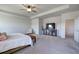 Main bedroom with a large TV, seating area and carpet flooring at 201 Augusta Walk, Canton, GA 30114