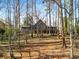 Back of the home is surrounded by trees creating a peaceful and private setting at 3520 Still Rd, Cumming, GA 30041