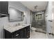 Bathroom features a dark vanity with marble countertop and tiled shower at 3520 Still Rd, Cumming, GA 30041