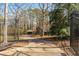 Gated driveway leads to a private home nestled among mature trees, offering seclusion and curb appeal at 3520 Still Rd, Cumming, GA 30041