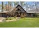 Stunning home boasts a unique architectural design, lush lawn, and stone walkway leading to the front door at 3520 Still Rd, Cumming, GA 30041