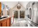 Bright kitchen with views of the yard features stainless steel appliances and a large island at 3520 Still Rd, Cumming, GA 30041