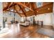 Expansive living space showcasing a soaring wood ceiling, large windows, and hardwood flooring at 3520 Still Rd, Cumming, GA 30041