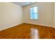 Simple bedroom with hardwood floors and large window at 4299 High Country Dr, Douglasville, GA 30135