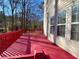 Red stained deck overlooks a wooded backyard at 4299 High Country Dr, Douglasville, GA 30135