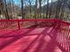 Spacious deck with red railing and wooded view at 4299 High Country Dr, Douglasville, GA 30135