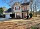 Two-story house with stone accents, red shutters, and a two-car garage at 4299 High Country Dr, Douglasville, GA 30135