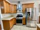 Kitchen features stainless steel appliances and oak cabinets at 4299 High Country Dr, Douglasville, GA 30135