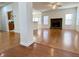 Hardwood floor living room, stone fireplace, and kitchen view at 4299 High Country Dr, Douglasville, GA 30135