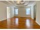 Large main bedroom with hardwood floors, coffered ceiling, and ceiling fan at 4299 High Country Dr, Douglasville, GA 30135