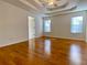 Large main bedroom with hardwood floors, coffered ceiling, and ceiling fan at 4299 High Country Dr, Douglasville, GA 30135