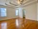 Main bedroom with hardwood floors and tray ceiling at 4299 High Country Dr, Douglasville, GA 30135