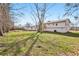 Home's expansive backyard featuring mature trees and green grass at 2185 Rochelle Way, Atlanta, GA 30349