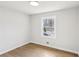 Bedroom featuring hardwood flooring and a large window providing natural light at 2185 Rochelle Way, Atlanta, GA 30349