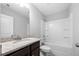 Clean bathroom with granite countertop, dark brown vanity, and shower/tub combo at 6117 Summerstone Ln, Douglasville, GA 30135