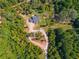 Aerial view of house, driveway, and surrounding woods at 701 Jones Mill Rd, Whitesburg, GA 30185