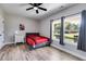 Bright bedroom with a double bed, wood floors, and large windows at 701 Jones Mill Rd, Whitesburg, GA 30185