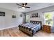 Main bedroom with a large bed, ceiling fan, and wood floors at 701 Jones Mill Rd, Whitesburg, GA 30185