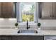 Kitchen sink with granite countertops and farmhouse style at 701 Jones Mill Rd, Whitesburg, GA 30185