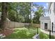 Landscaped backyard with wooden fence, and small shed at 1010 Edgewater Dr, Atlanta, GA 30328