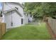 Backyard with fence, retaining wall, and grassy lawn at 1010 Edgewater Dr, Atlanta, GA 30328